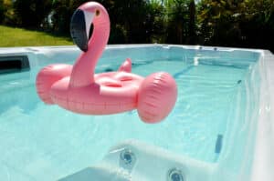 a inflatable pink flamingo pool floatie in a swim spa
