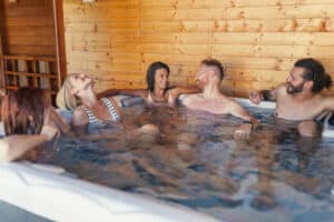 a group of friends in a hot tub on vacation at home