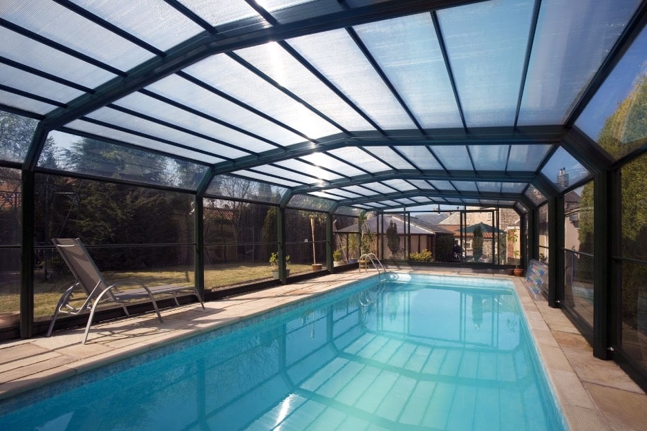A pool enclosure over an inground pool. 