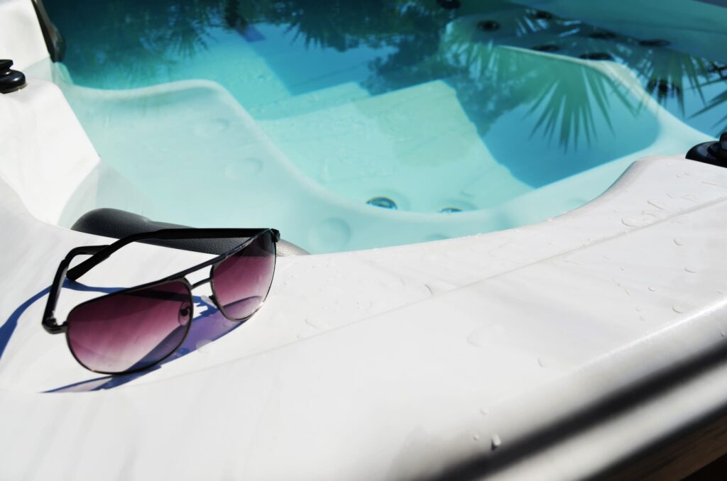 Sunglasses on the side of a hot tub