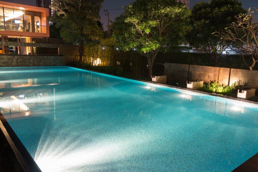 A pool with beautiful lighting enjoying the fruits of a HFS Financial loan.