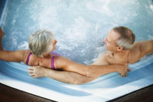 couple soaks in a hot tub or spa