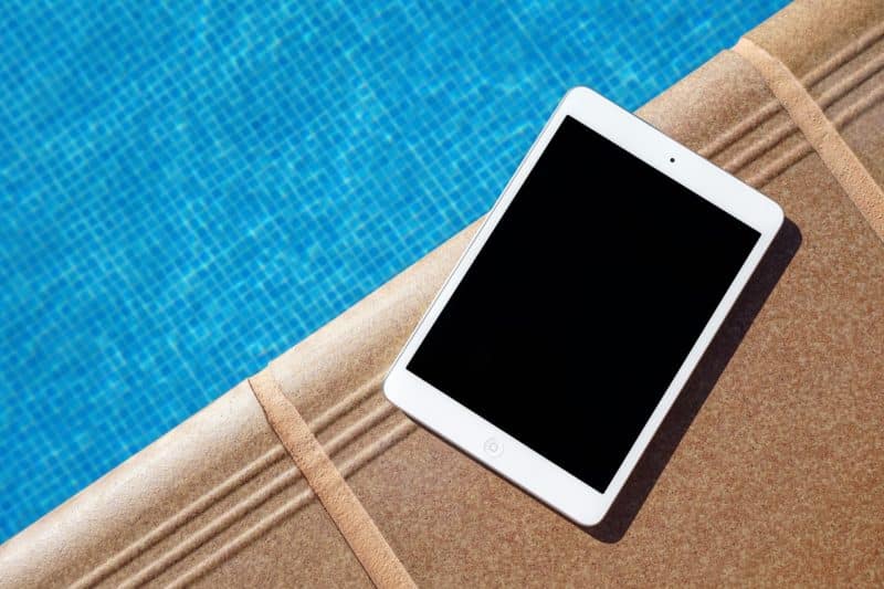 iPad sitting on the edge of a pool