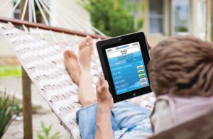 Middle aged woman using pool and spa automation software on tablet