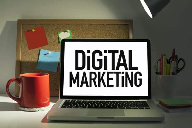 Macbook displaying the words "digital marketing"