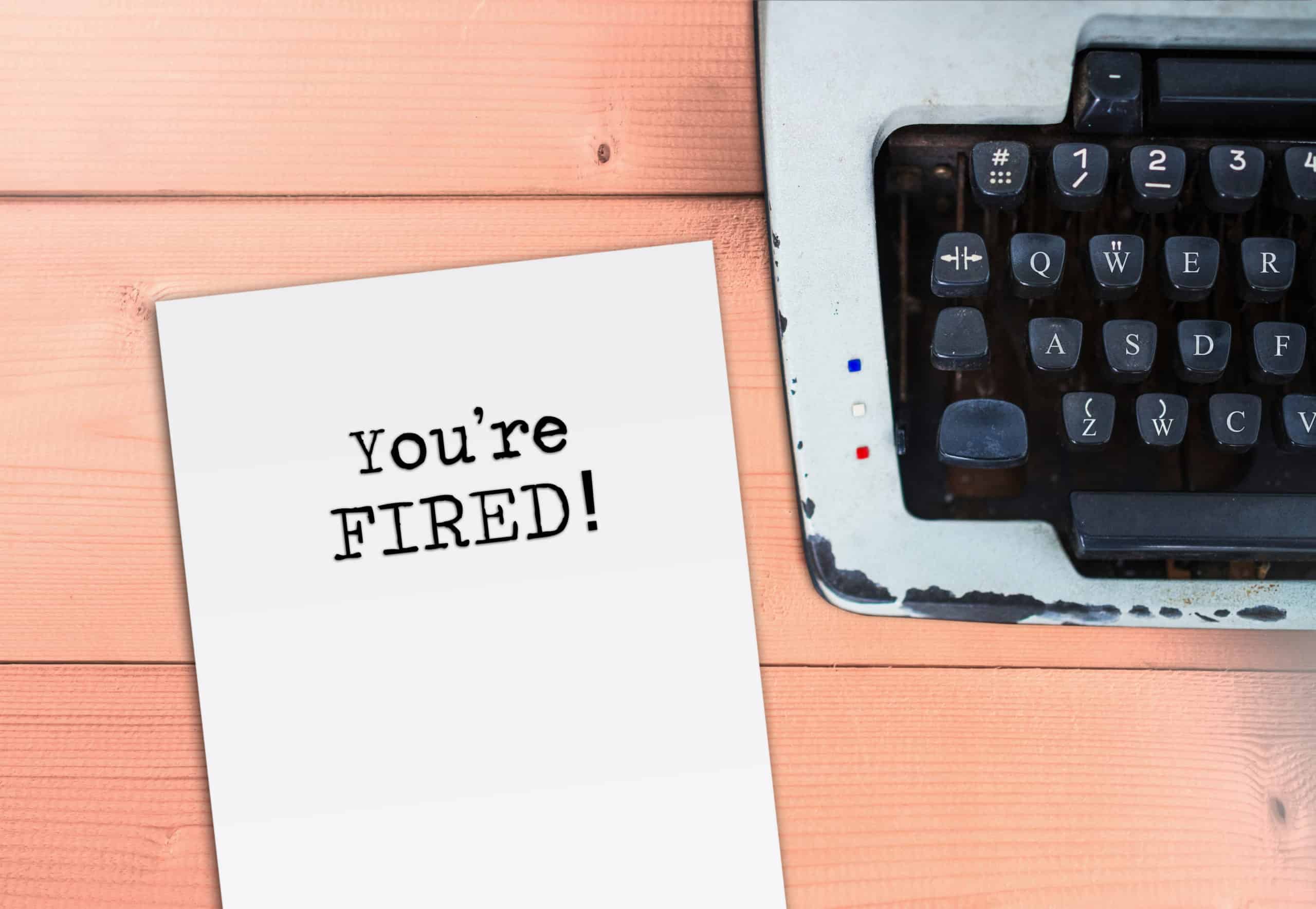 the words "You're FIRED!" typed on a piece of paper