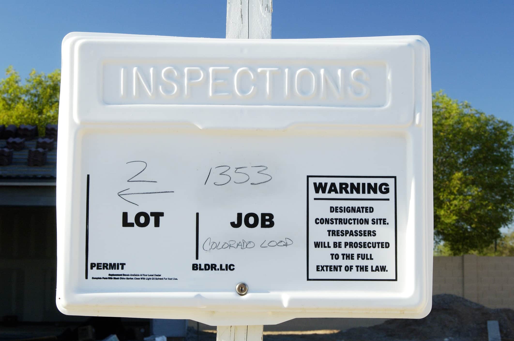White sign that says "Inspections"