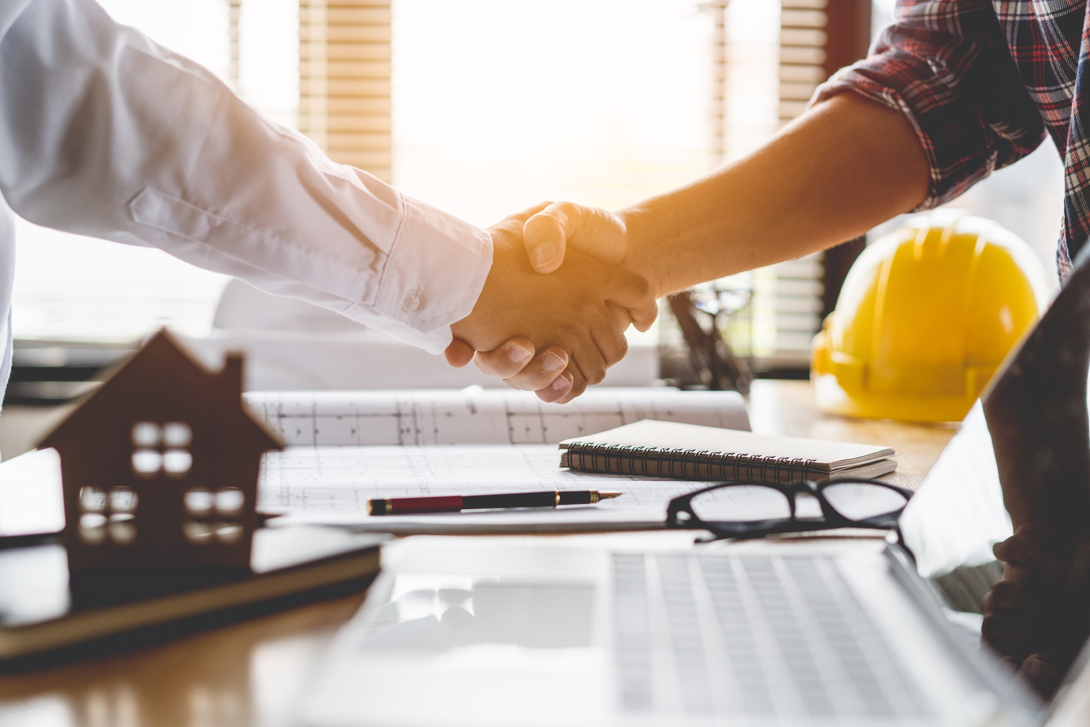 General contractor shaking hands with healthy competition