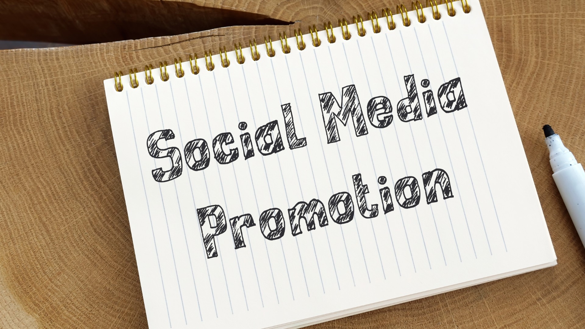 Notebook that says "Social Media Promotion"