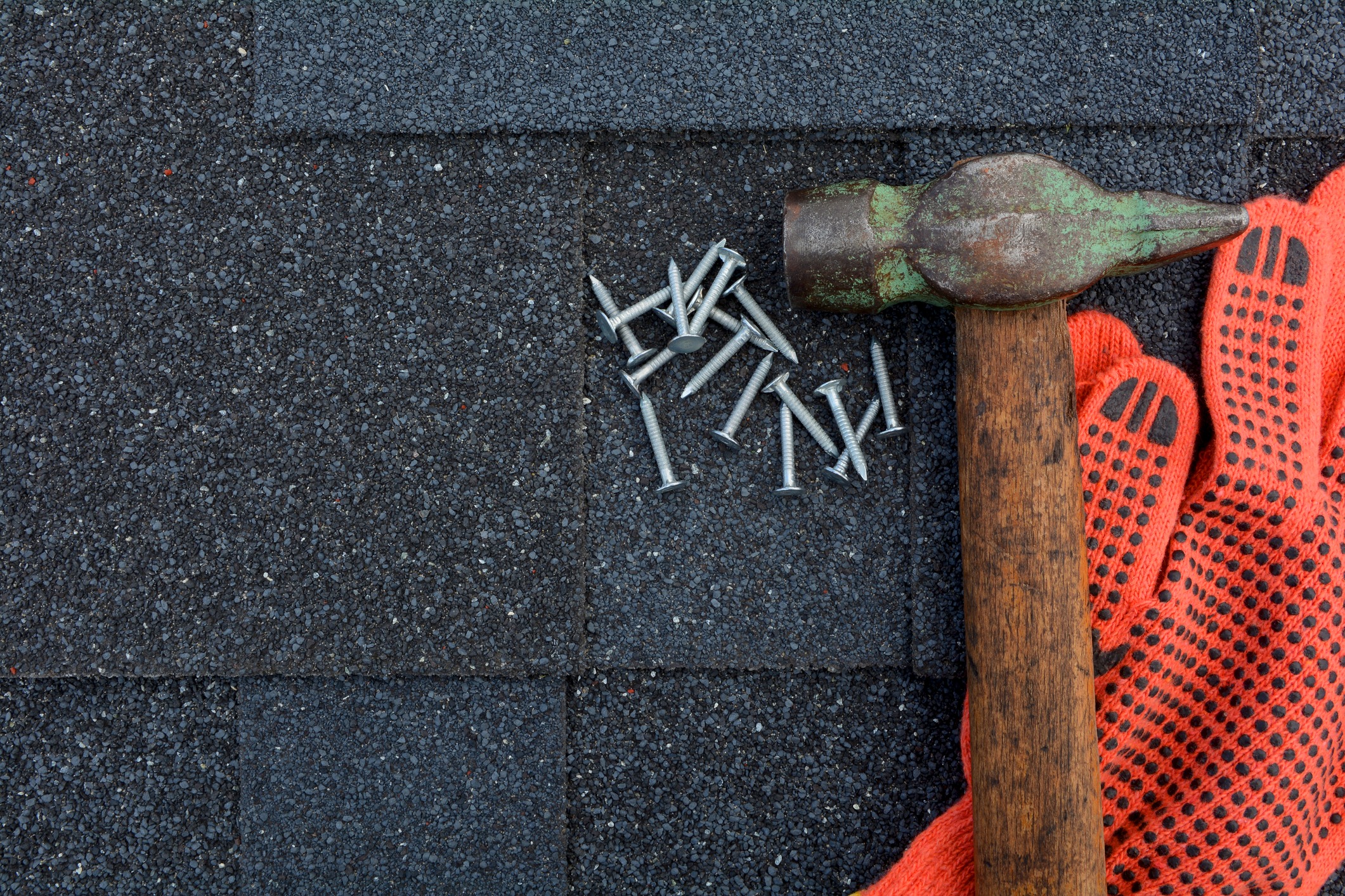 Hammer and nails on new roof tiling