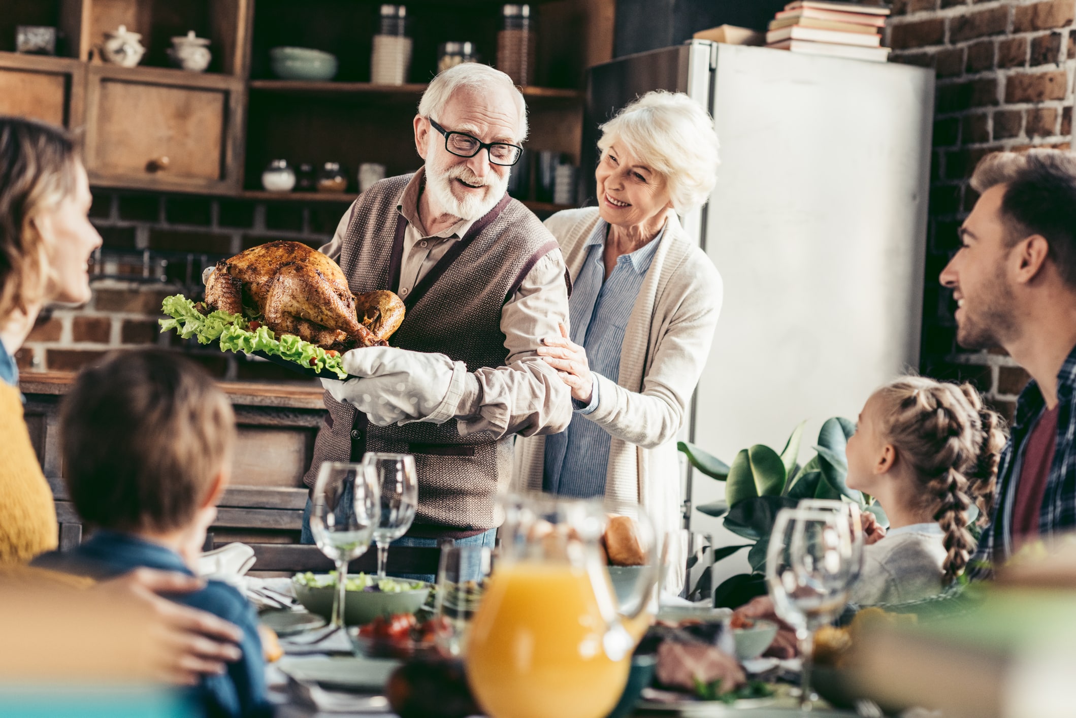 Family gathered at dinner table for holiday turkey
