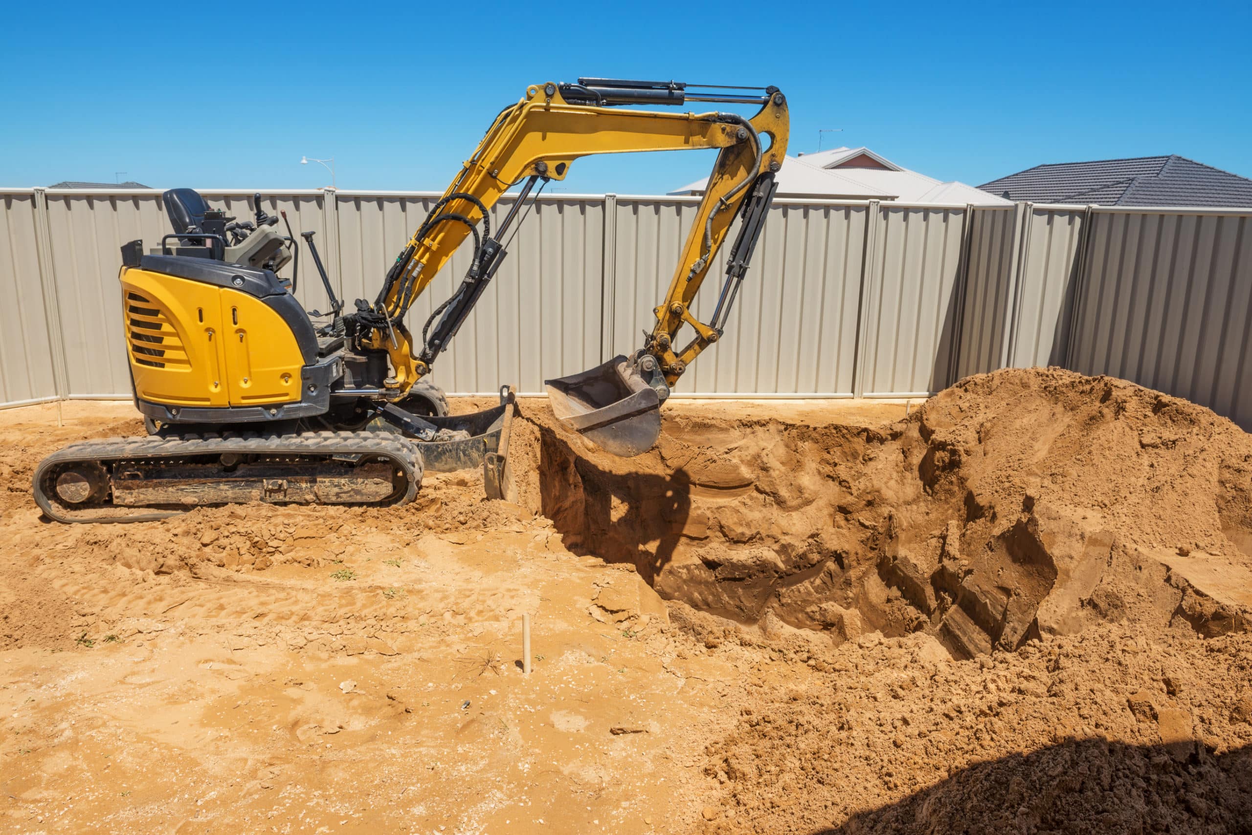 an excavator digs for a pool build