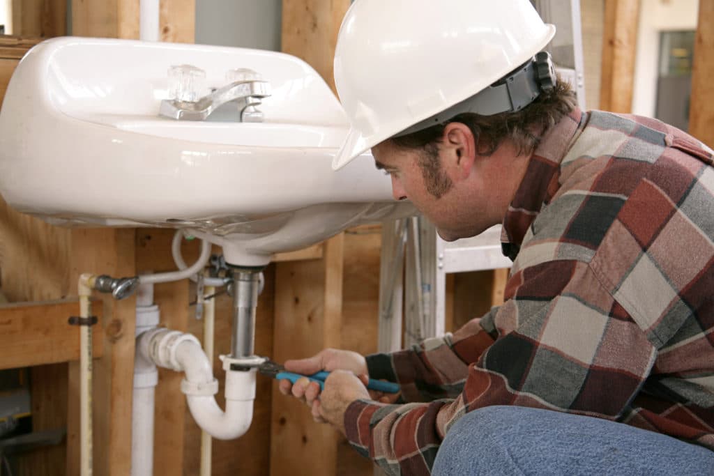 a contractor learns new skills like plumbing a sink in order to thrive in the off-season