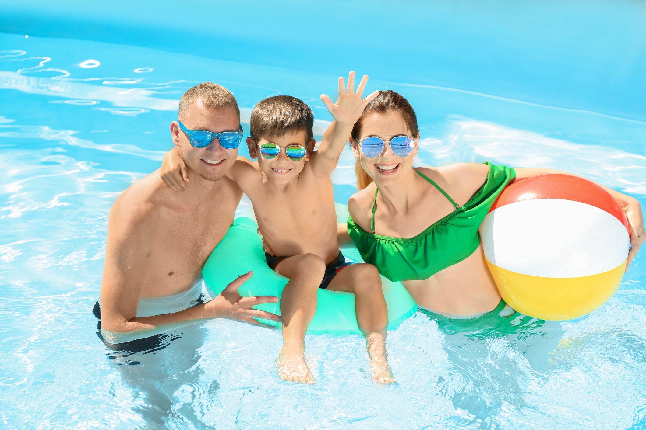 Small family enjoying swimming pool