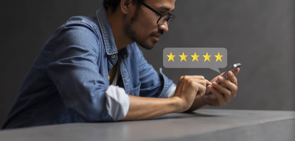 A contractor checks his online reviews on his phone. He has five stars and is dominating the competition.