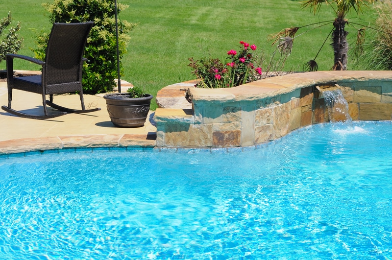 Luxury swimming pool with beautiful backyard landscaping