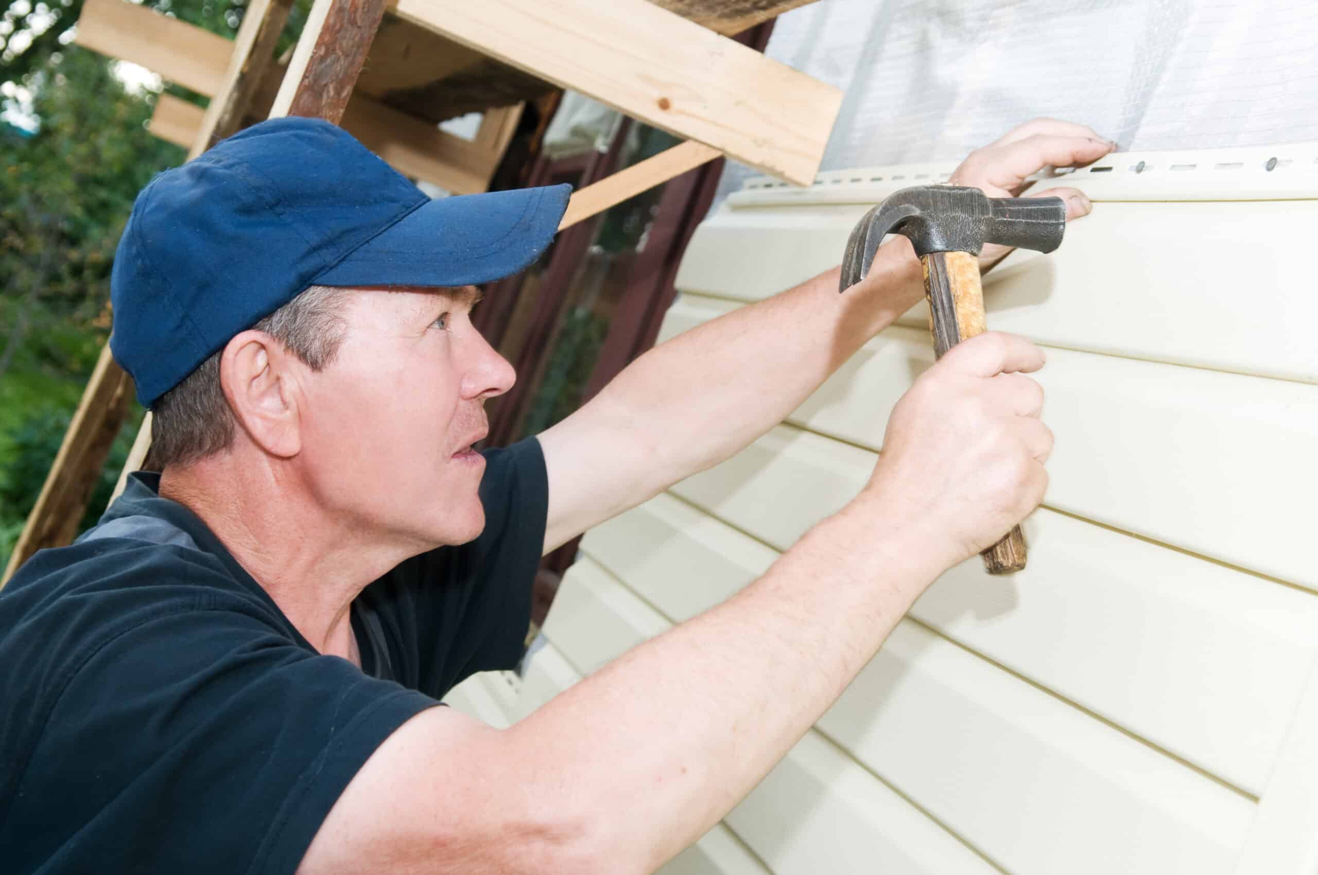 A gutter and siding contractor installs new house siding with a hammer. That's how you dominate the competition in your market.