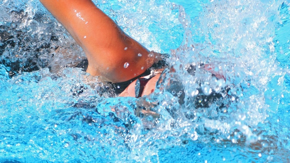 A man swimming in a swim spa
