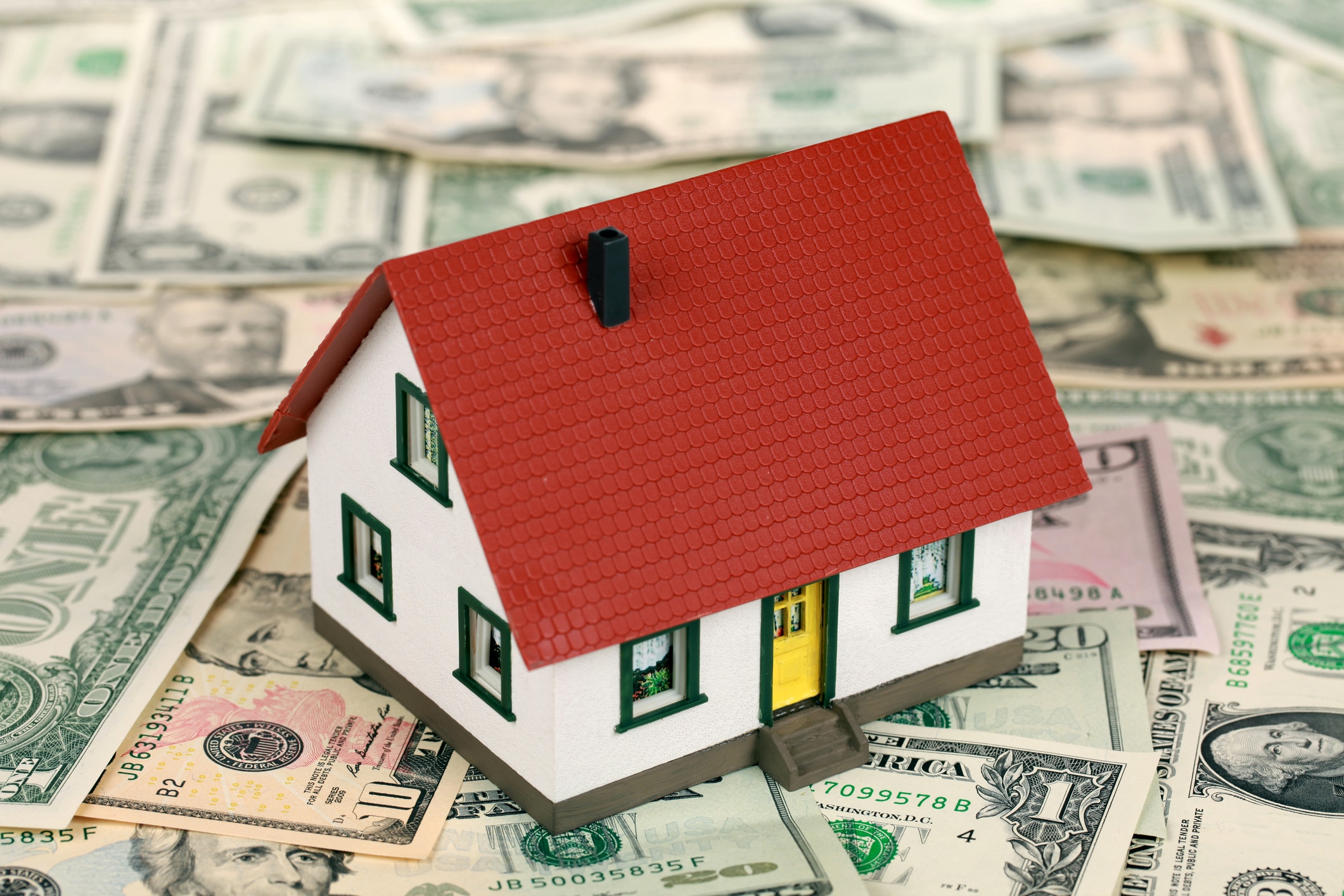 home improvement financing represented with a small house on green USA money