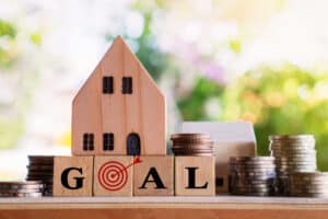 a house with blocks that say goal with money for a home improvement loan