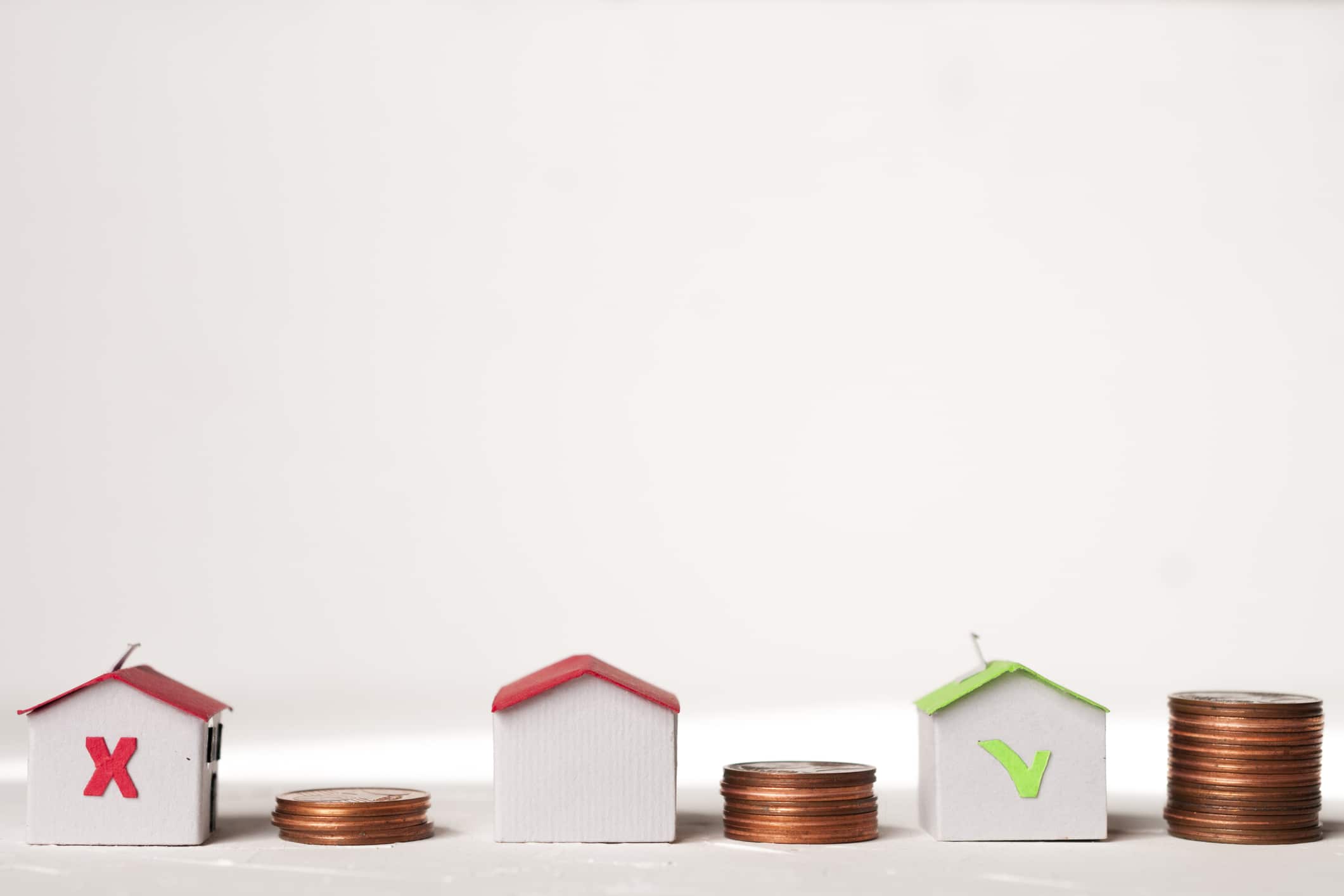 paper houses with coins representing home improvement loan rates
