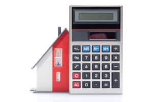 A house behind a calculator for home improvement financing. Learn how to offer financing to my customers.