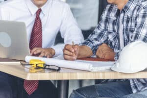 A contractor meets with a client to discuss financing for contractors