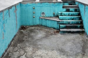 An empty dirty old pool that needs a renovation pool loan
