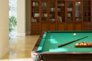 Pool table and small library in man cave